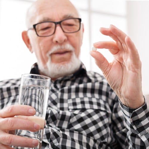 Man holding antibiotic pill