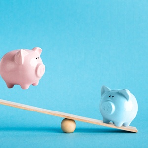 Piggy banks on balance scale