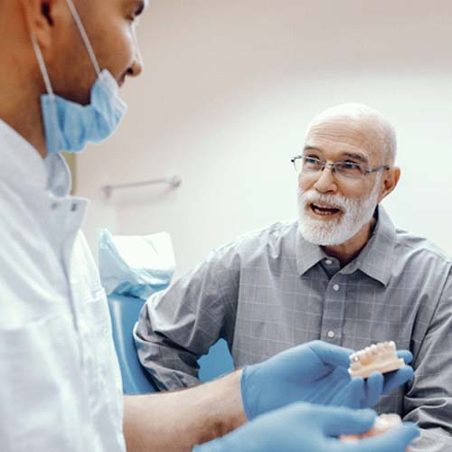 man at a consultation with his denture dentist in Fort Myers