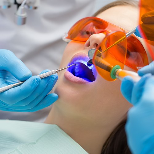 Closeup of a tooth reflected in dental mirror