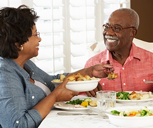 A smiling senior couple eating healthy foods