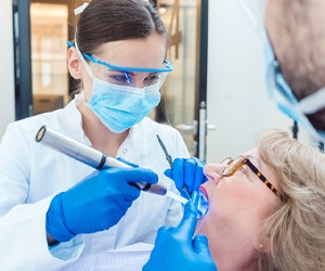 Implant dentist in Fort Myers performing exam on a patient