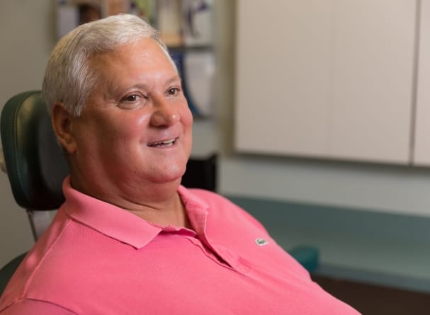 Dental patient smiling after dental crown restoration