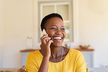 Woman smiling while talking on phone