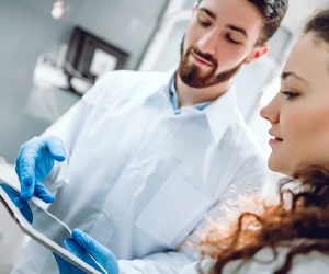 Dentist and patient discussing different dental implant options