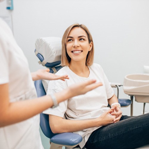 patient smiling while talking to dentist 