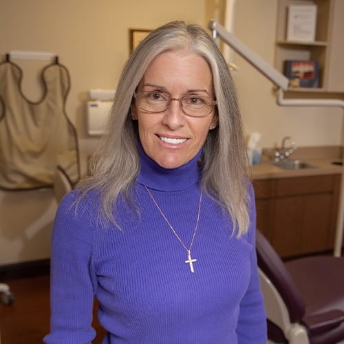 Woman smiling after fluoride treatment