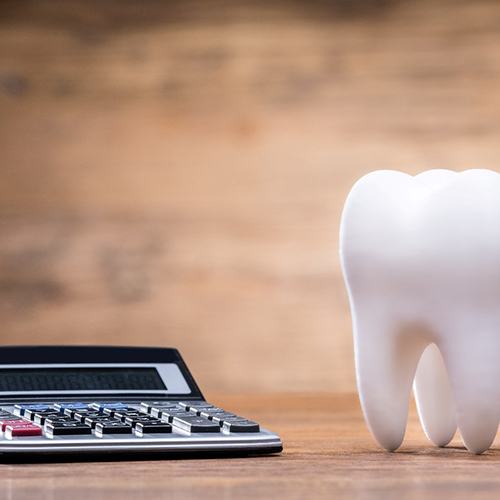 Close-up of calculator and model of a tooth