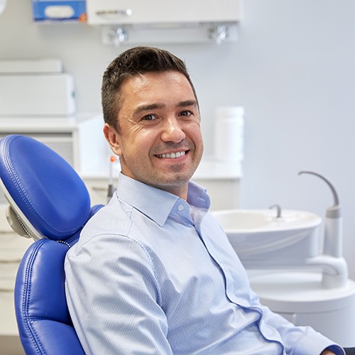 A smiling man who received effective dental care