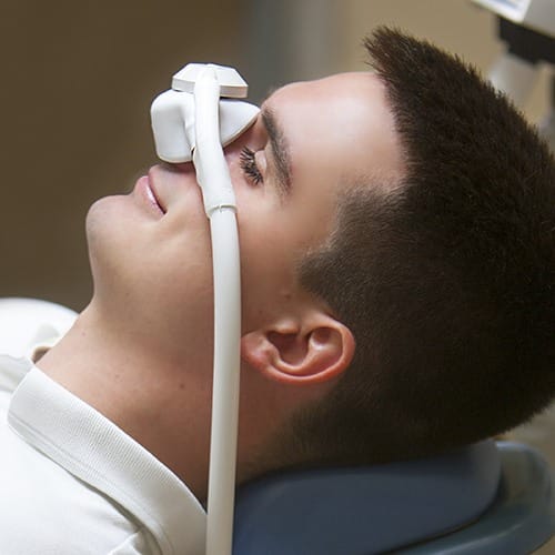 Dental patient wearing inhaled sedation dentistry nose mask