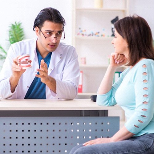 Dentist discussing how a smile makeover works with patient 
