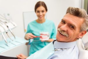 man talking to his dentist about dentures 