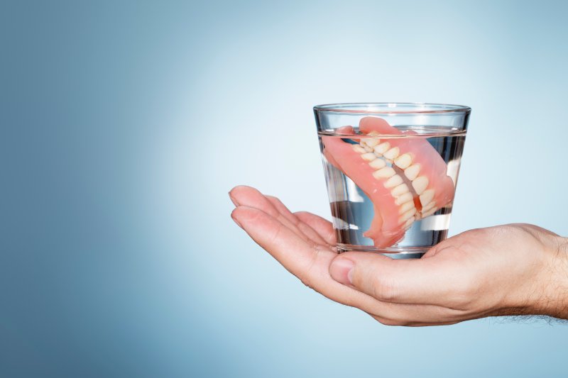Close-up of dentures in glass of water