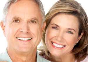 Smiling senior couple enjoying the benefits of mini dental implants