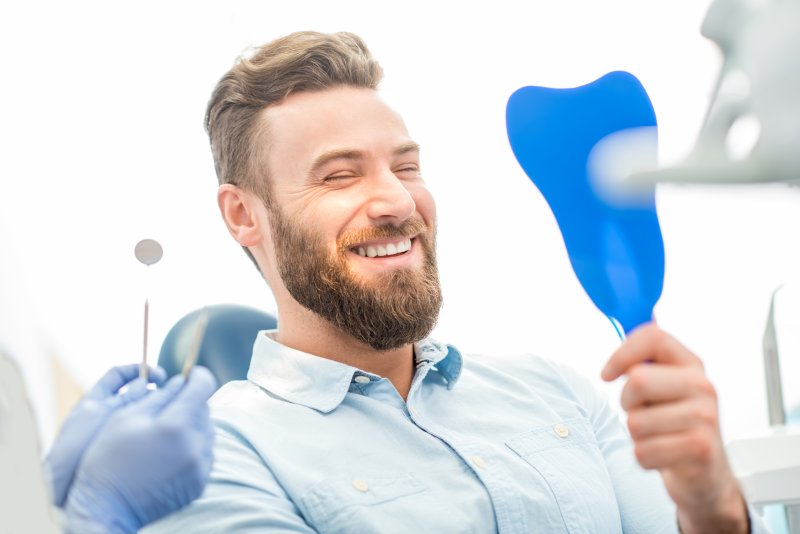 person smiling after having small teeth fixed